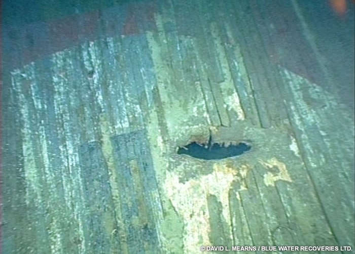 Shell hole in the forward swastika deck marking