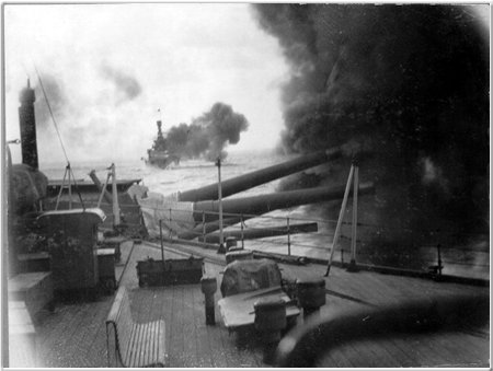 Hood fires a salvo from her rear turrets