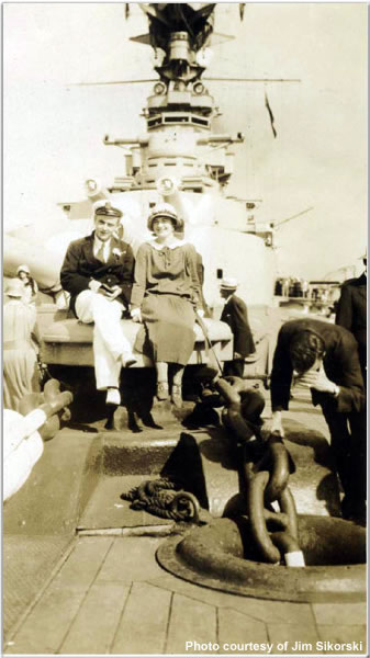 Man and woman sitting atop one of Hood's capstans