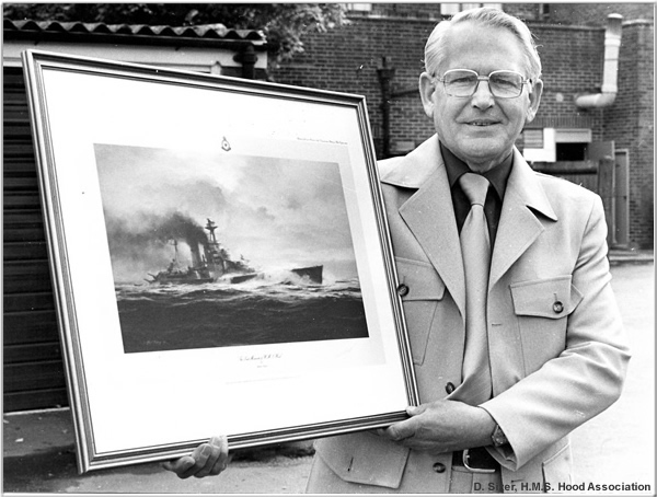 Douglas posing with a painting of H.M.S. Hood